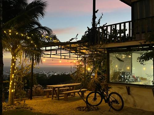 a bike parked outside of a building with a table at Peaceful Hill Homestay in Ke Ga