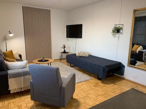 a living room with a bed and a chair at Cozy 2BR Apartment KA64 with sauna in Oulu
