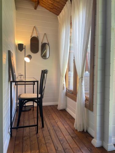 a dining room with a table and a window at Jacaranda Cottage 5 min by Train or 7 min drive to Parramatta City in Wentworthville