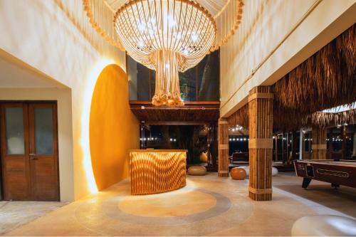 a lobby with a large chandelier and a pool table at Sea Sun Bed & Beyond in Bang Rak Beach