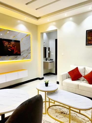 a living room with a couch and a table at SN suites apartment in Kampala