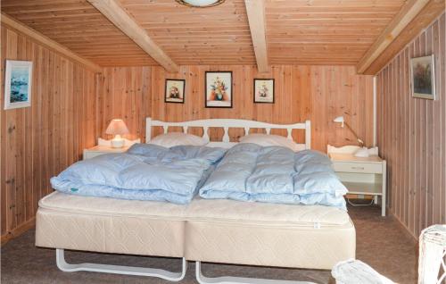 a bedroom with a bed with blue pillows on it at Three-Bedroom Holiday Home In Saby in Sæby