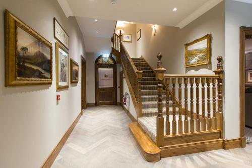 a staircase leading up to a living room filled with furniture at The Station Hotel in Rothes