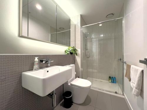 a bathroom with a sink and a toilet and a shower at 1 BR 1 BATH, Southern Cross, Balcony in Melbourne