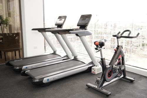 two treadmills and a treadmill in a room with a window at Villa Isabel Hotel in Sorsogon