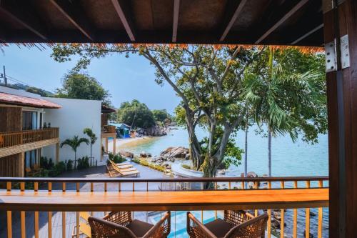 a view of the water from the balcony of a resort at Sea Sun Bed & Beyond in Bang Rak Beach