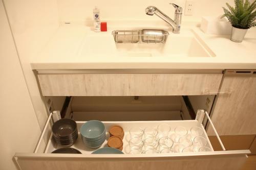a bathroom sink with a drawer under a sink at Casa Stella 18 by Liaison in Osaka