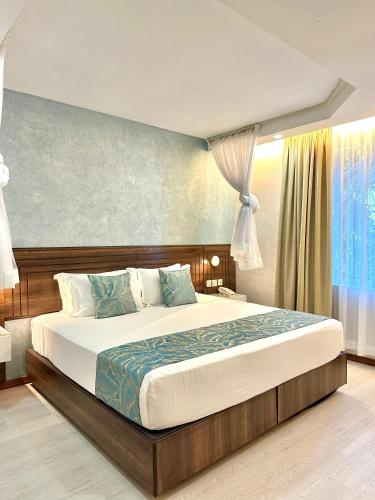 a bedroom with a large bed in a room at La Fattoria Resort in Mombasa