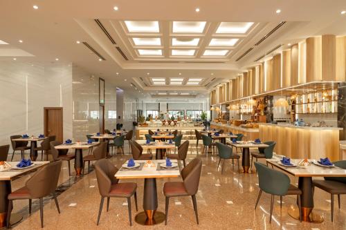 an image of a restaurant with tables and chairs at PANAMA Nha Trang Hotel in Nha Trang