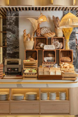 a display case with bread and other food items at PANAMA Nha Trang Hotel in Nha Trang