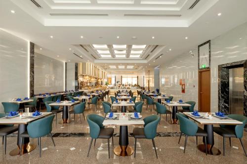 a rendering of a restaurant with tables and chairs at PANAMA Nha Trang Hotel in Nha Trang