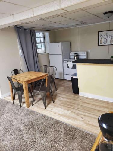a kitchen with a wooden table and chairs in a room at Two Kitchens Family Friendly in Forestdale in Birmingham