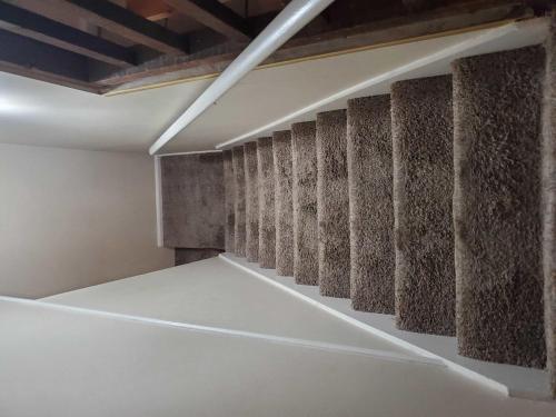 a room with a wall of concrete dividers at Two Kitchens Family Friendly in Forestdale in Birmingham