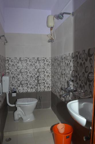 a bathroom with a toilet and a sink at Andaman Castle in Port Blair