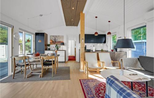 a living room and kitchen with a table and chairs at Amazing Home In Bogø By With Wifi in Bogø By