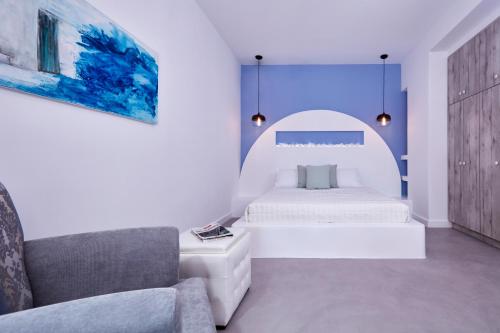 A bed or beds in a room at Orabel Suites Santorini (Adults Only)