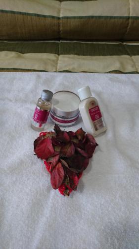 a pile of roses and someentedented items on a bed at Hotel Albergaria Senhora do Espinheiro in Seia