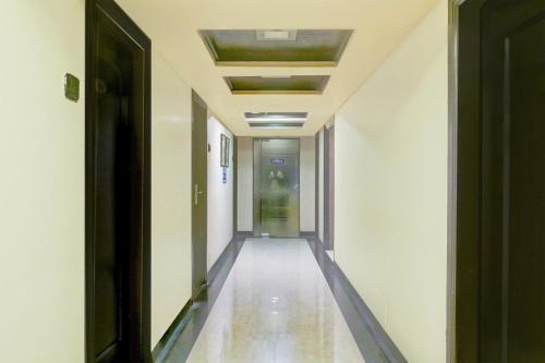an empty corridor in a building with a hallway at Townhouse Oak JM Road Formerly Krishna presidency in Pune