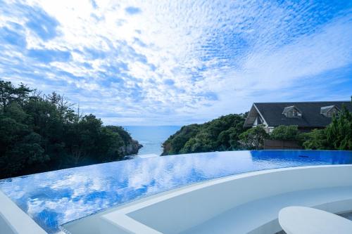 a swimming pool with a view of the water at TAOYA Shirahama Senjyo in Shirahama