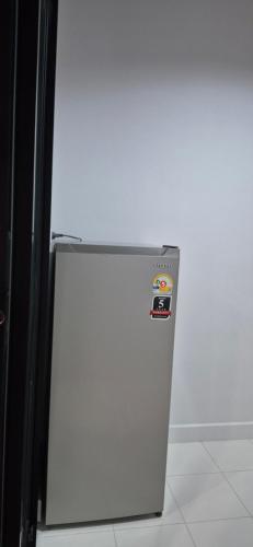 a white refrigerator freezer sitting in a kitchen at Love me home in Yala