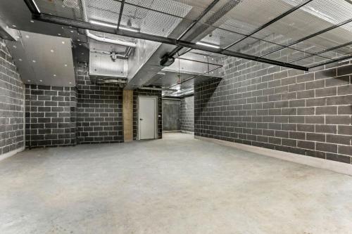 an empty room with a brick wall at Family-friendly entire Lux 4BR Home 2 parking in Miranda