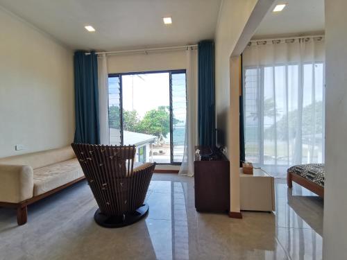 a living room with a couch and a large window at coral coast FIJI in Sigatoka