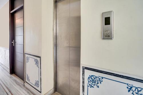 an elevator door in a building with blue and white tiles at Super Townhouse Durgapura formerly Gumaan Heritage in Jaipur