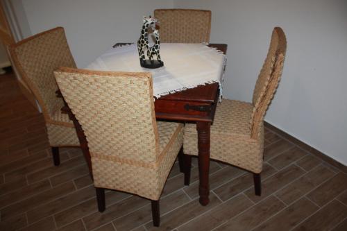 a dining room table and chairs with a white table at La Conchiglia Tra i Due Mari in Trapani
