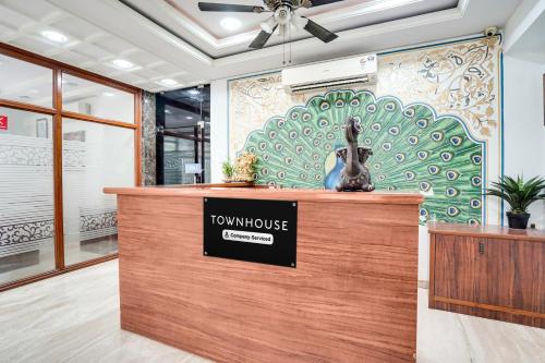a town house with a sign on top of a counter at Super Townhouse Durgapura formerly Gumaan Heritage in Jaipur