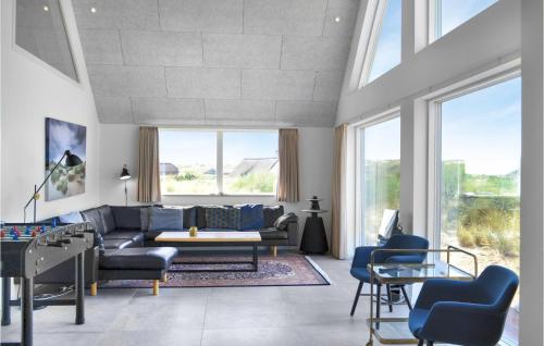 a living room with a couch and a table at Lovely Home In Ringkøbing With Sauna in Ringkøbing