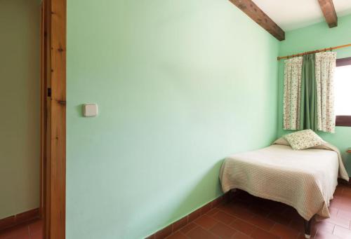 Ένα ή περισσότερα κρεβάτια σε δωμάτιο στο Hostal de la Rovira