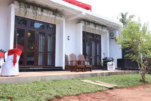 a woman in a hijab sitting on the porch of a house at Indunil place hiriketiya in Dickwella