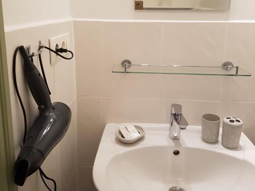 a black phone sitting on top of a bathroom sink at Apartamenti Strand in Saulkrasti