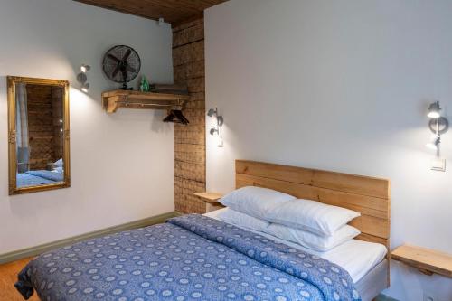 a bedroom with a bed and a mirror at Apartamenti Strand in Saulkrasti