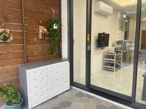 a store front with a glass door and plants at 黎明背包客棧Sunrise Backpackers Hostel in Hualien City