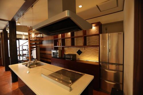 a kitchen with a sink and a refrigerator at ハンドインハンド岡山後楽園まで徒歩約5分 in Okayama