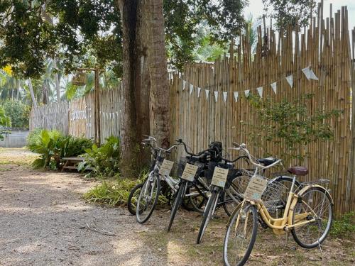 a group of bikes parked next to a fence at บ้านพราวพร้าว Baan Proud Proud in Khanom
