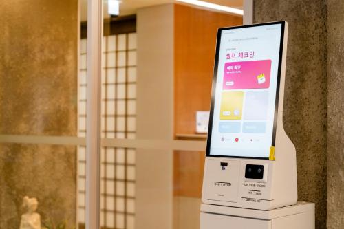 an electronic device with a screen on a wall at Jamsil Stay 509 in Seoul