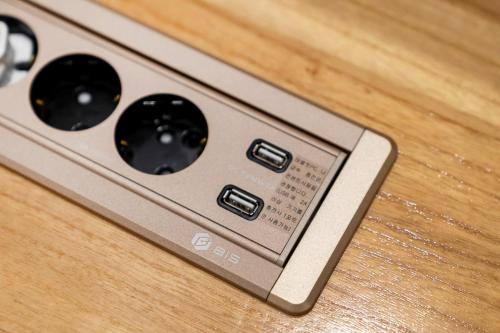 a remote control sitting on top of a wooden table at Jamsil Stay 509 in Seoul