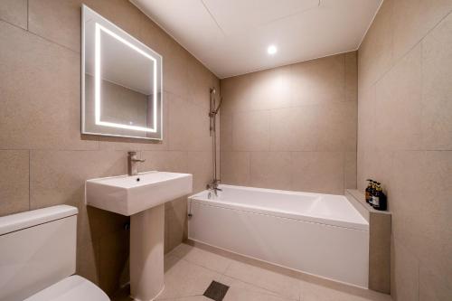 a bathroom with a sink and a tub and a toilet at Jamsil Stay 509 in Seoul