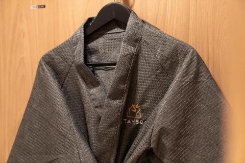 a jacket is hanging on a wooden wall at Jamsil Stay 509 in Seoul