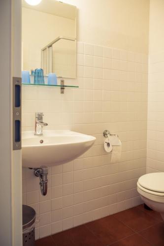 a bathroom with a sink and a toilet at Grafschaft in Jüterbog