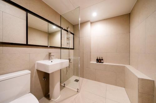 a bathroom with a sink and a toilet and a shower at Jamsil Stay 509 in Seoul