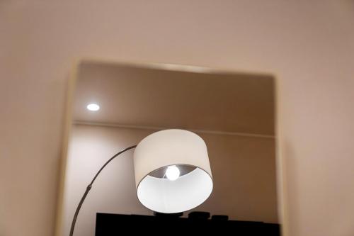 a white lamp sitting on a table in a room at Jamsil Stay 509 in Seoul