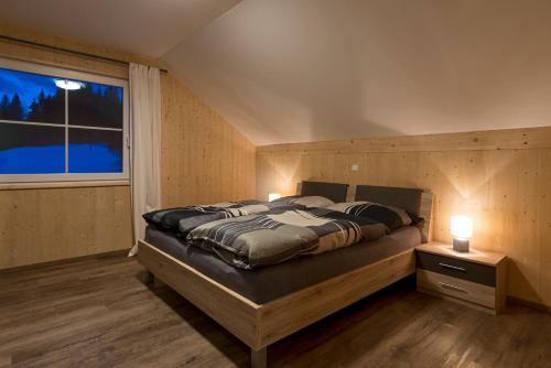 a bedroom with a large bed and a window at Haus Loserblick in Altaussee