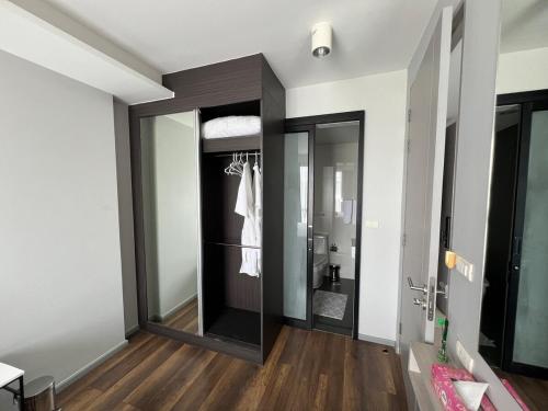 a bathroom with a walk in shower and a mirror at Condo Surin-Bangtao Beach in Ban Lum Fuang