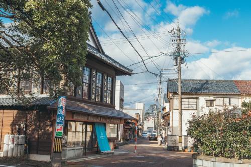 an old building on the corner of a street at Auberge Homachi Mikuniminato in Sakai