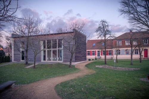 a building with trees and a path in front of it at Grafschaft in Jüterbog