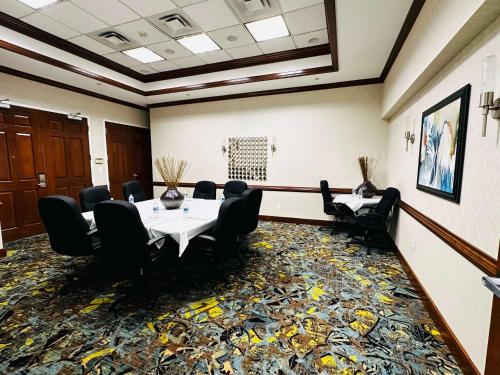 a meeting room with a table and black chairs at Hampton Inn Alexandria/Old Town in Alexandria