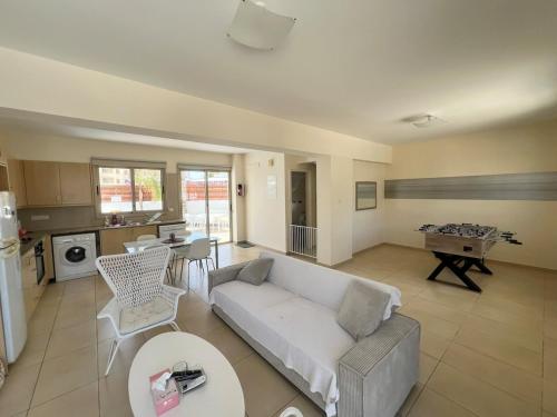 a living room with a couch and a table at Amour Et Citrons in Protaras